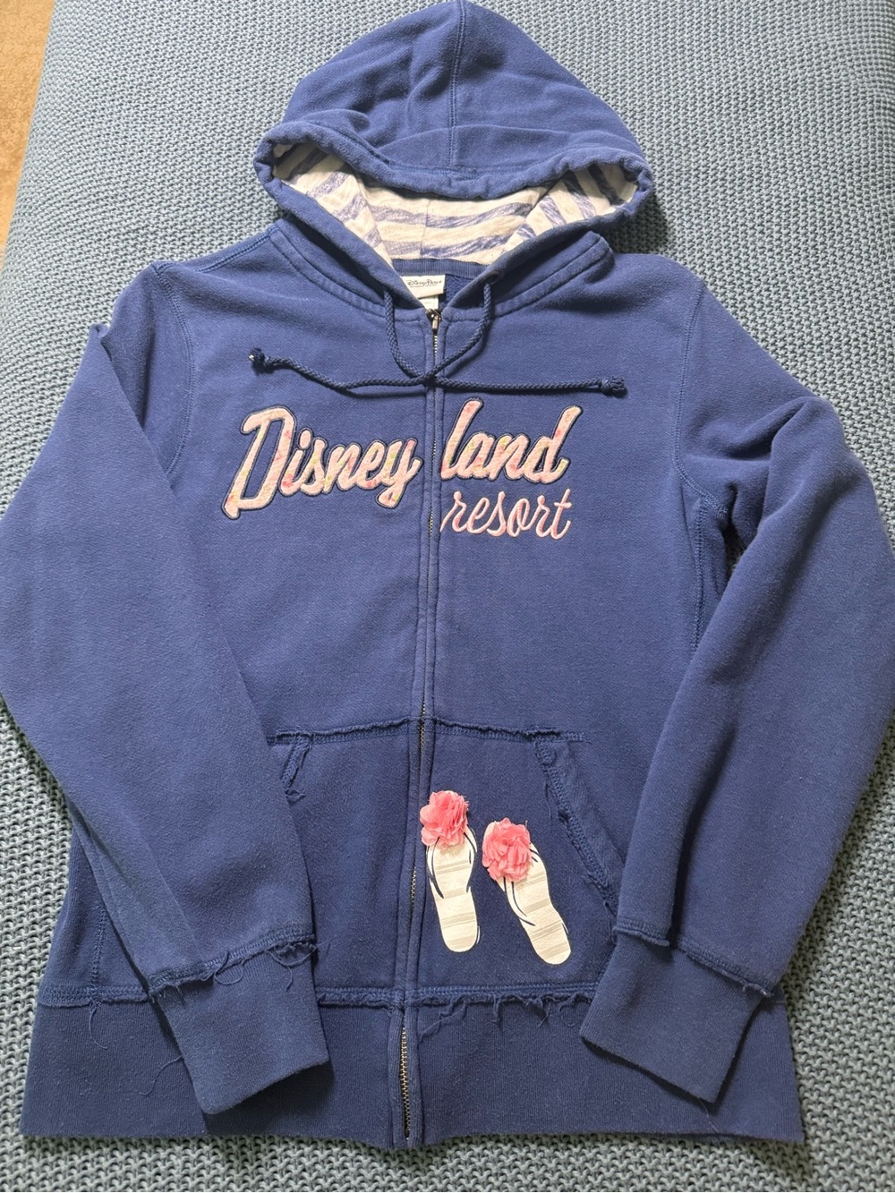 Disney navy zip-front hoodie with pink appliqué